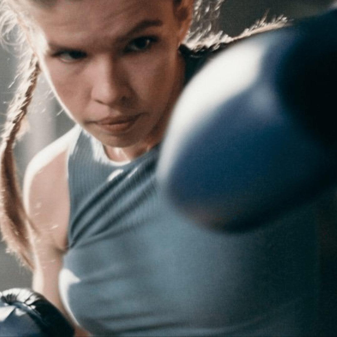 Female boxer throwing a punch for a Take Your Best Shot photography campaign.