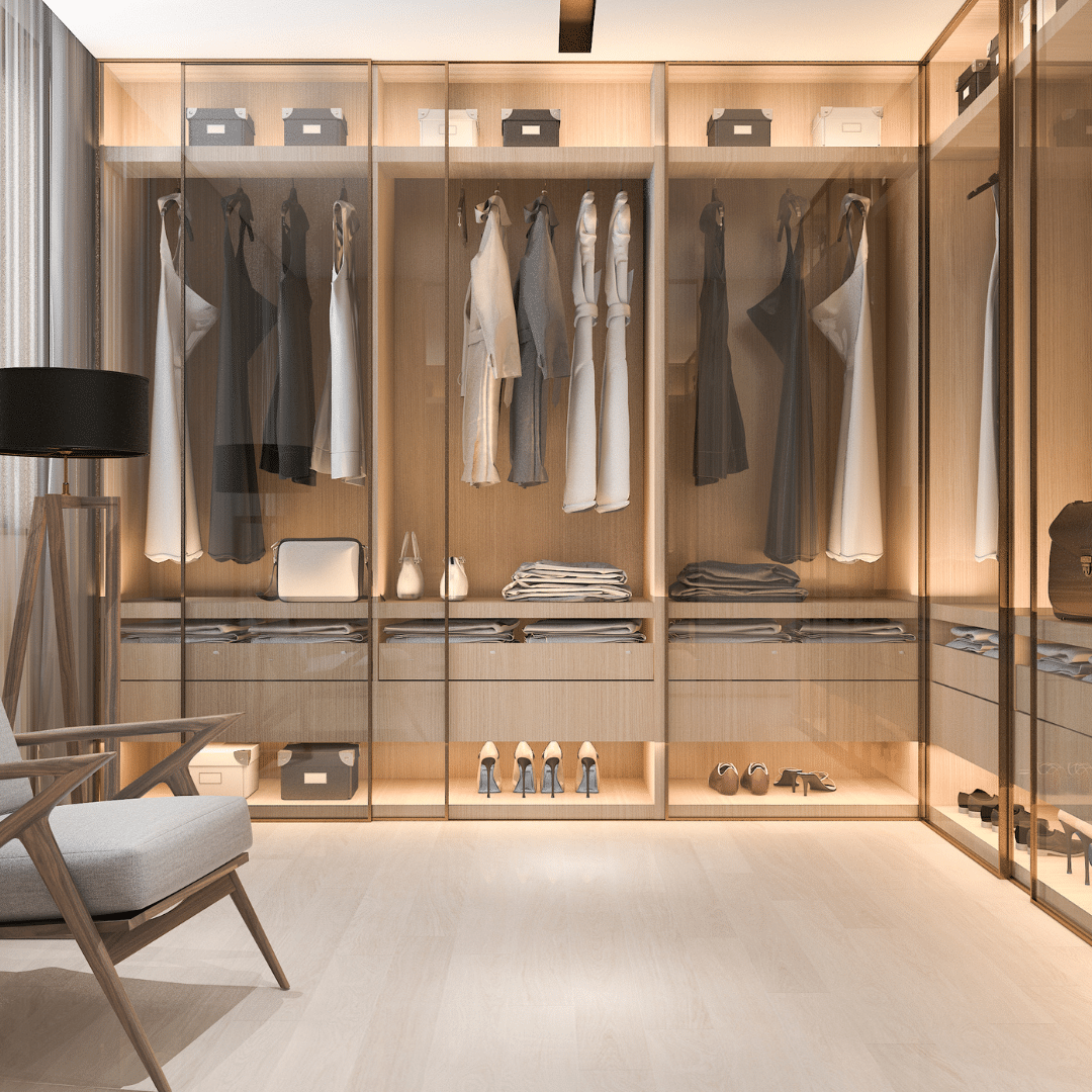 Modern custom closet with glass doors, built-in storage, and organized clothing in Jupiter Florida.