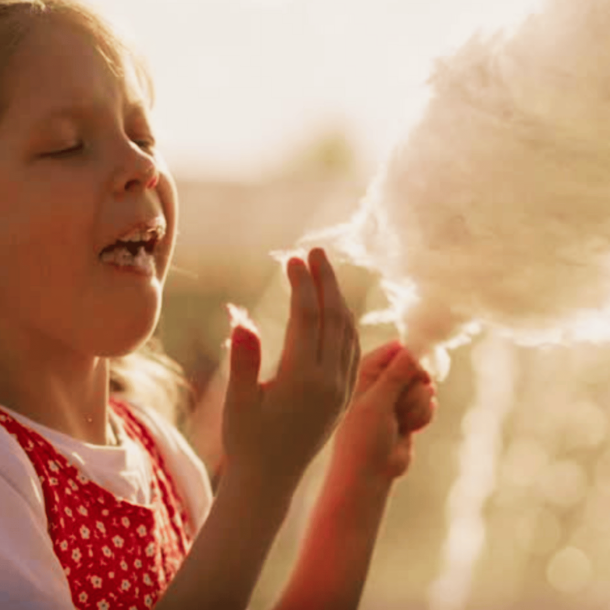 Child Enjoying Cotton Candy In Warm Sunlight, Representing The Playful And Memorable Feel Of Boofkay’s Ads That Stick In Jupiter Florida.