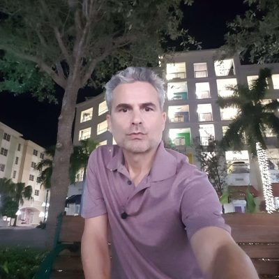 Ryan May sitting outside at Harbourside Place in Jupiter, Florida at night.